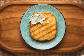 Delicious toast for breakfast on a beautiful plate on a wooden tray.