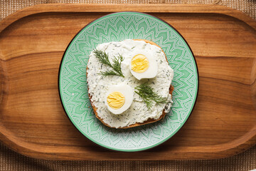 Delicious toast for breakfast on a beautiful plate on a wooden tray.