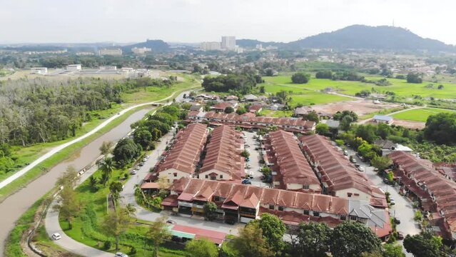 Drone view of modern small houses surrounded by greenery 