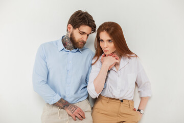 Fashion couple, beautiful woman and handsome man with beard and hairstyle in fashionable casual outfit on a white background