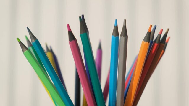 Children's colored crayons pencils on a white background, close-up