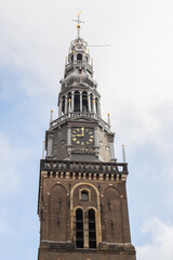 Fototapeta na wymiar Old church tower (Oude Kerk) on the Oudekerksplein in the center of Amsterdam.