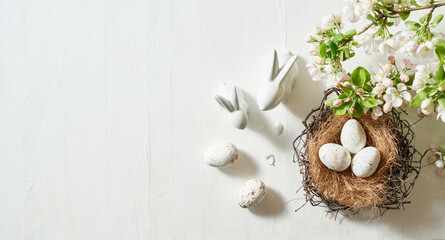 Holiday composition with spring flowers and easter eggs on a light background. Happy easter flat lay concept
