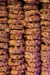 Oat and corn flakes cookies. Healthy natural food. Rows are stacked on top of each other. Vertical photo.