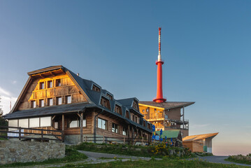 Television transmitter and chalet on Lysa Hora, beskid mountains, Czech republic at summer sunset time.
