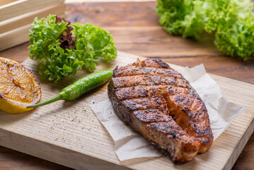 Grilled salmon steak on a board