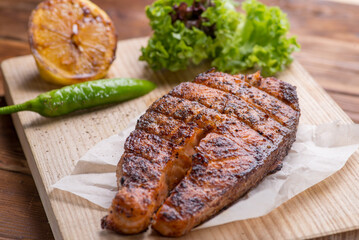 Grilled salmon steak on a board