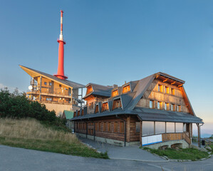 Television transmitter and chalets on Lysa Hora, beskid mountains, Czech republic at summer sunset time.