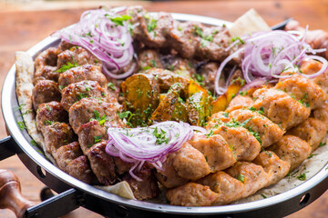 Different grilled steaks on a big bowl.