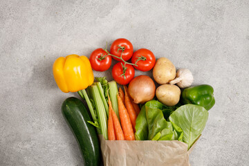 Healthy food in paper bag vegetables and on stone background. Food delivery, shopping food supermarket concept. Healthy food background. 