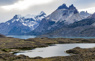Fototapeta na wymiar Impressive mountains and a lake with turquoise water at Torres del Paine National Park in Chile, Patagonia, South America