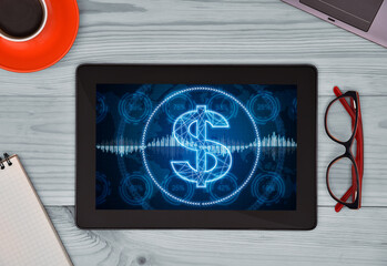 Digital tablet with glowing virtual dollar symbol