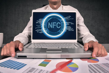 Near field communication hologram on screen laptop.