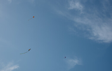 Colorful kite toy flying in the sky among clouds