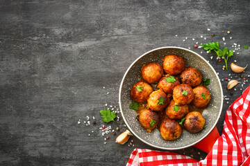 Meatballs in tomato sauce with herbs at dark table. Flat lay image with space for text. - obrazy, fototapety, plakaty