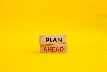 Plan ahead symbol. Wooden blocks with words Plan ahead. Beautiful yellow background. Business and Plan ahead concept. Copy space.