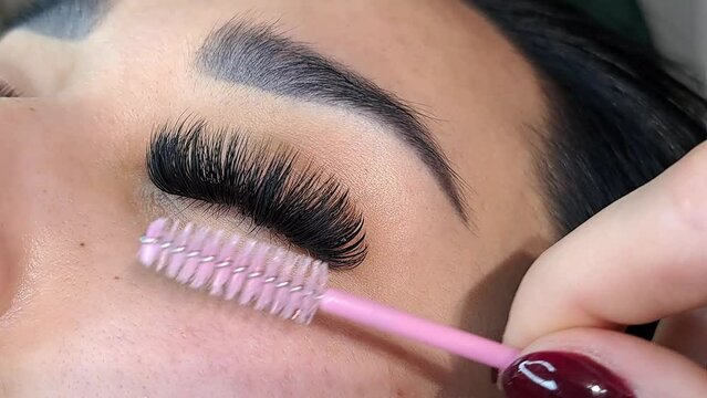Close up of eye with eyelash Extensions in beauty salon, mega russian volume