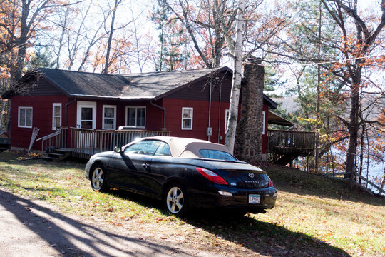 Sleek Toyota Solara convertible sport car parked by cabin on Sand Lake. Cumberland Wisconsin WI USA