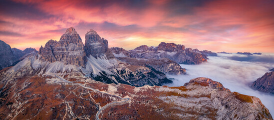 Foggy autumn sunset in Tre Cime Di Lavaredo National Park. Great evening view of Dolomite Alps,...