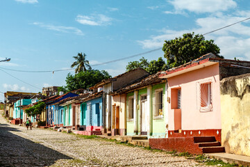 Fototapeta na wymiar Cobblestone street with old colonial houses in the center of Trinidad, Cuba, Caribbean