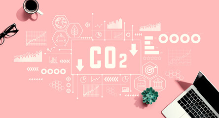 Reduce CO2 theme with a laptop computer on a pink background