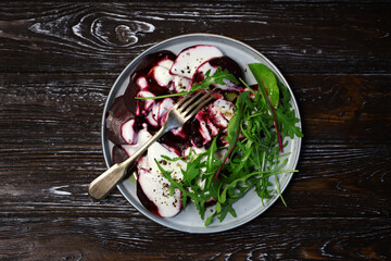 Healthy salad with beets and arugula with yogurt dressing. Vegan style food.