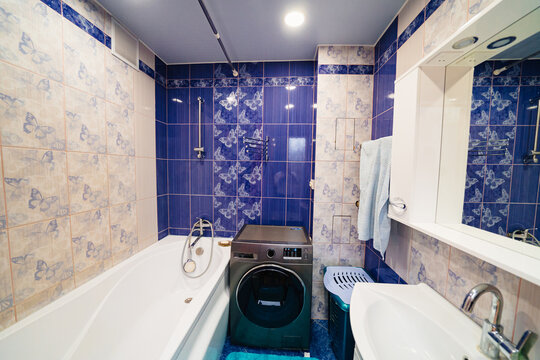  bathroom interior with blue ceramic tiles on the walls. 