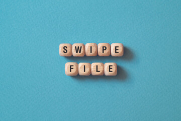 Swipe file - word concept on cubes, text