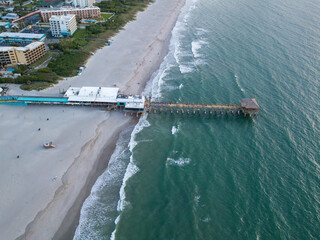 Aerial view of the Cocoa Beach Pier during sunrise. 