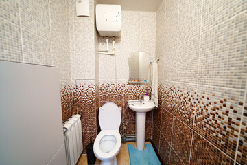 small toilet room with toilet and sink. 