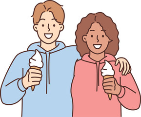 Smiling interracial couple hug eat ice cream