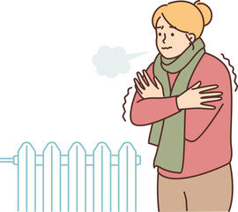 A woman freezes and stands in a room with a cold battery