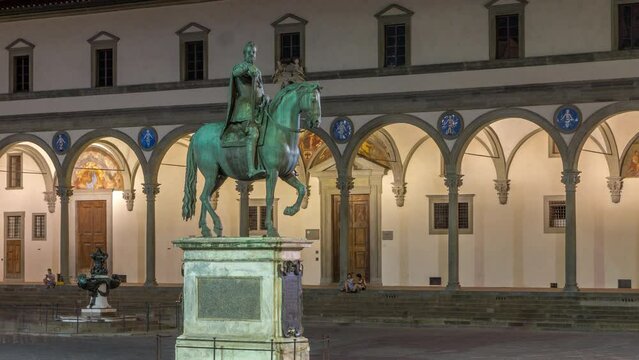 Statue of Ferdinando I de Medici side view night timelapse, Grand Duke of Tuscany, located in the Piazza della Santissima Annunziata in Florence, Italy