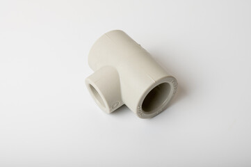 Fototapeta premium light PVC pipe tee connection for water isolated on light background close-up, connection for plumbing