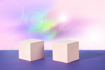 Cosmetic gradient background with len flare effect. Two white cubic podiums. Mockup for the demonstration of cosmetic products