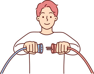 Man holding two cords with high voltage wish to connect wires to start electrical equipment