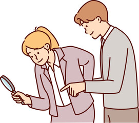 Fototapeta premium Man and woman working as detectives use magnifying glass during investigation to find evidence