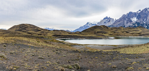 Impressive mountains and a lake with turquoise water at Torres del Paine National Park in Chile,...