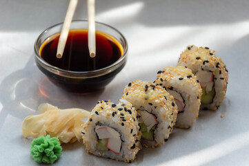 Sesame rolls with crab sticks, soy sauce and ginger
