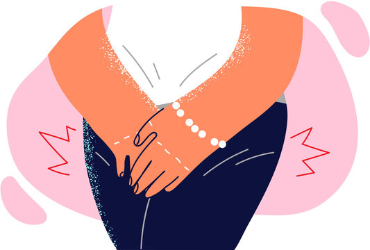 Woman presses hands to groin, having experienced sharp desire to visit toilet due to enuresis