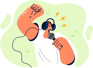 Positive man in headphones holding microphone enjoying singing in karaoke club while relaxing