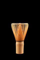 Chasen or Bamboo tea whisk on black background, close-up. Accessory for whipping Matcha tea