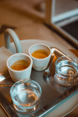 Enjoying speciality coffee in one of the best coffeeshop in Brussels. A closeup photo of two cups of espresso. 