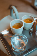 Enjoying speciality coffee in one of the best coffeeshop in Brussels. A closeup photo of two cups of espresso. 