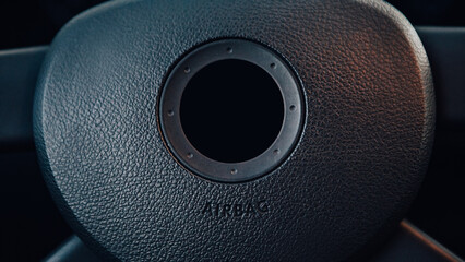 Close up steering wheel black dark car interior. Dashboard with speedometer display panel, airbag...