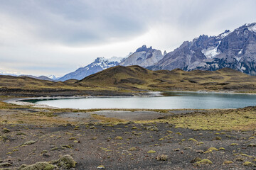 Impressive mountains and a lake with turquoise water at Torres del Paine National Park in Chile,...