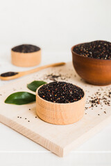 quinoa seeds in bowl and spoon on colored background. Healthy kinwa in small bowl. Healthy superfood