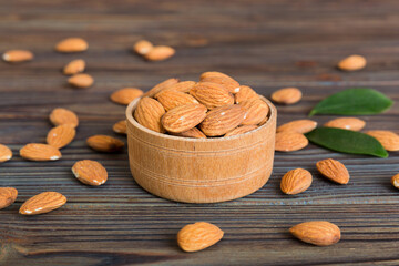 Fresh healthy Almond in bowl on colored table background. Top view
