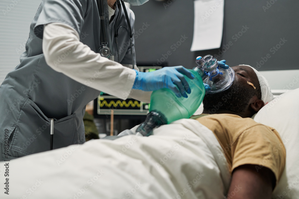 Poster nurse bending over sick man while checking oxygen mask or changing balloon in artificial lung ventil