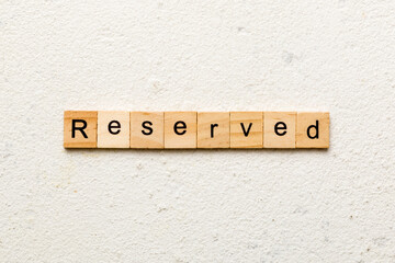 reserved word written on wood block. reserved text on cement table for your desing, concept